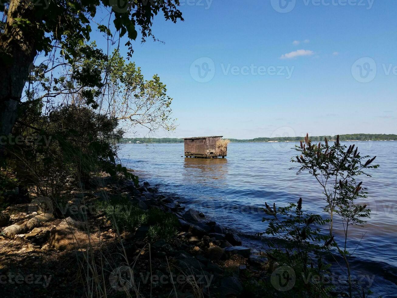 bird watching or fishing structure blind in water photo