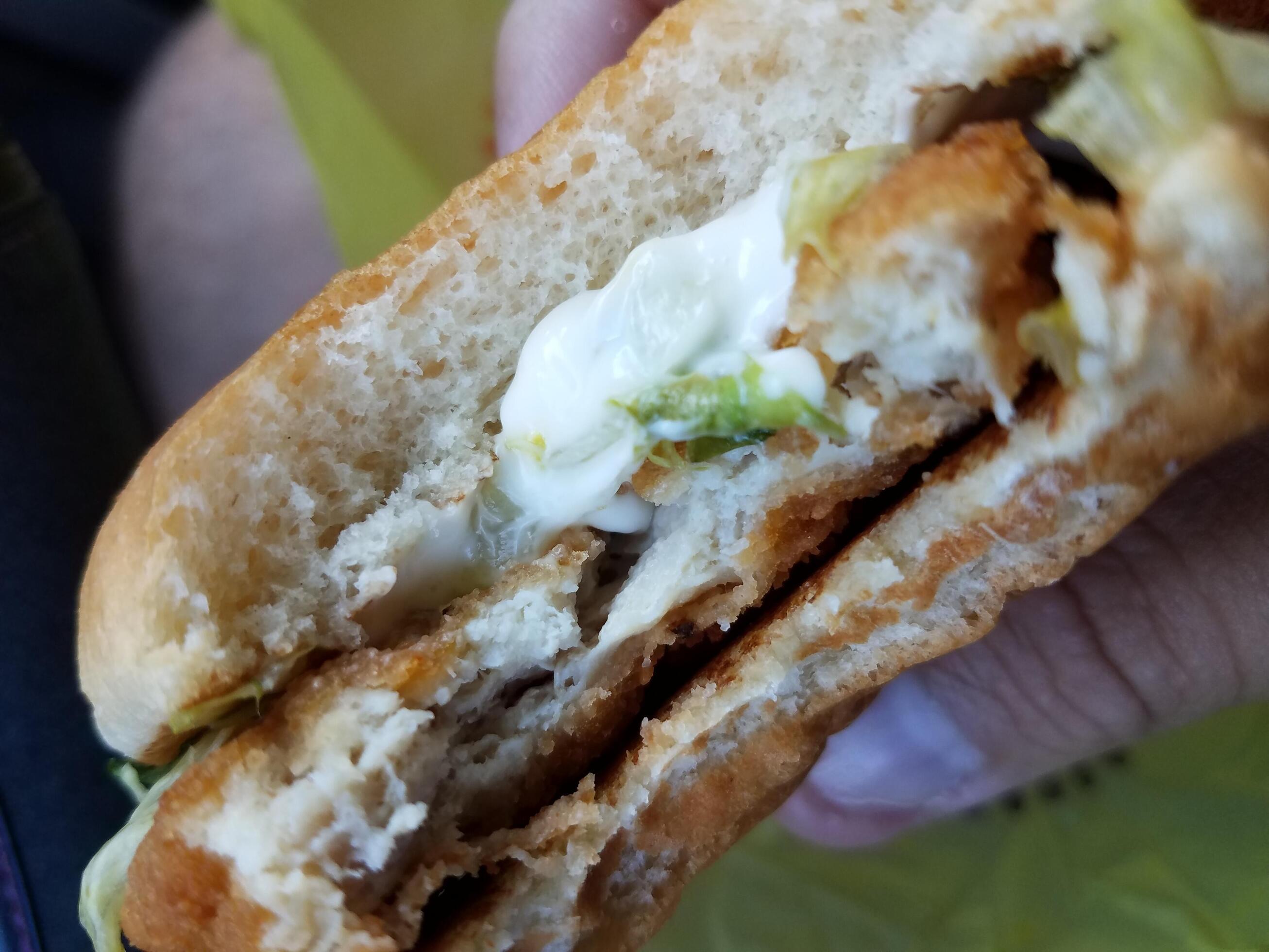 Sándwich de pollo mordido con lechuga y mayonesa 8202673 Foto de stock