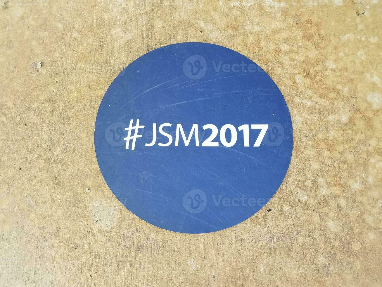 blue sticker on the ground that says JSM2017 photo