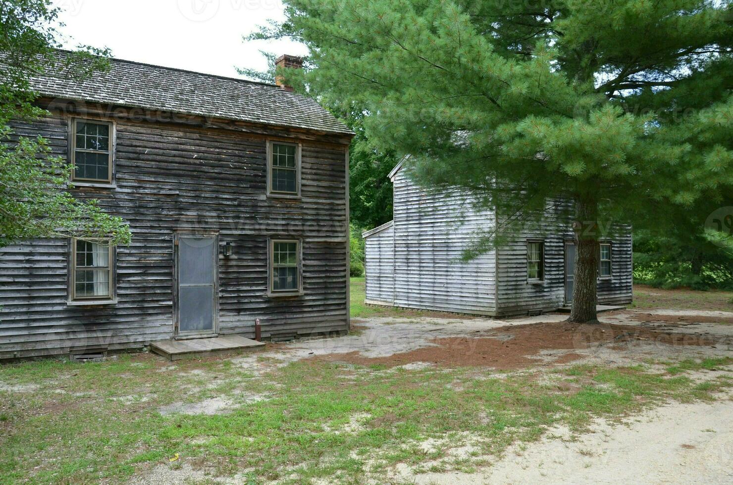 old wood ghost town homes or cabins with grass photo