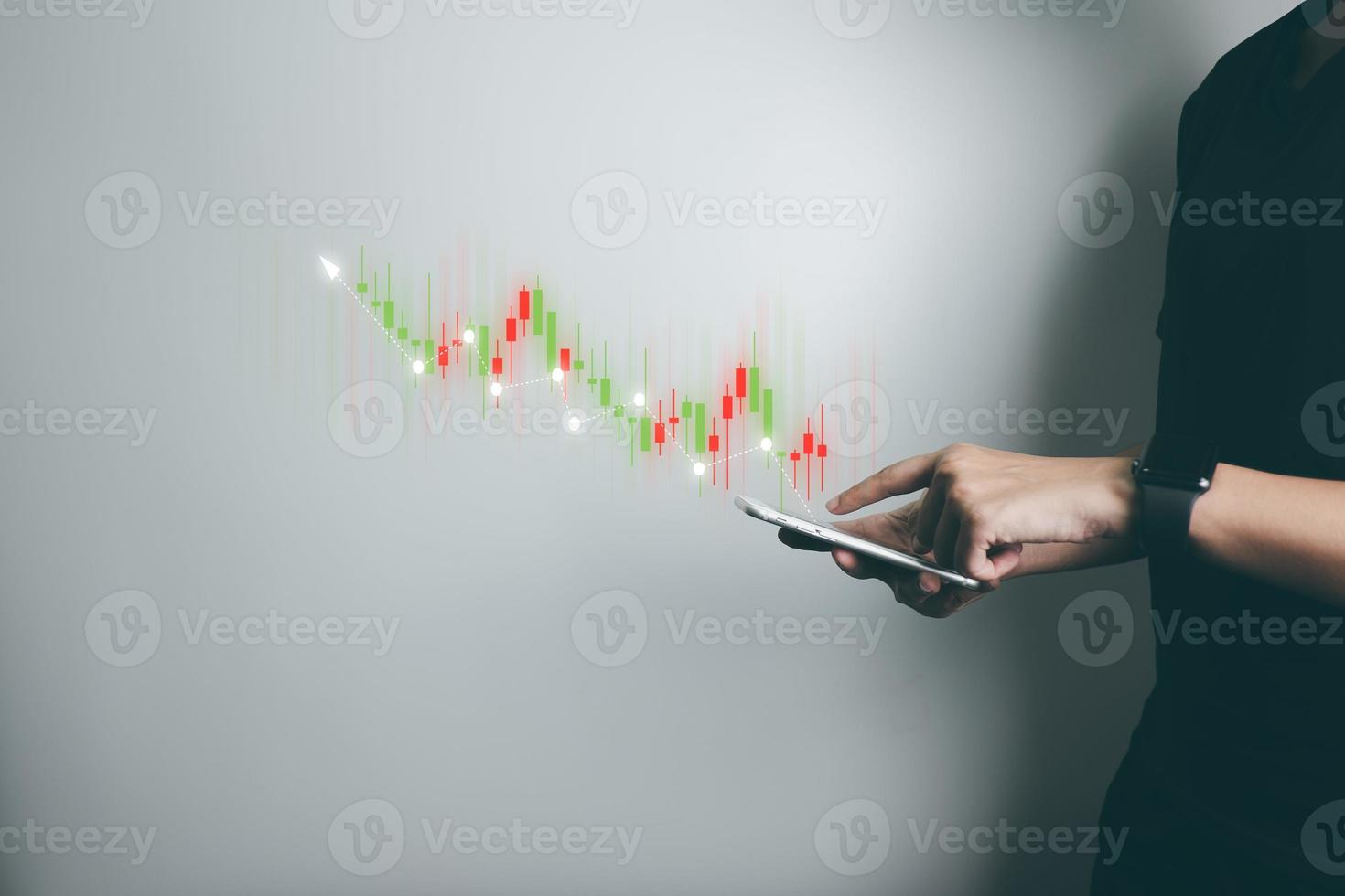 Investor is trading stock with smartphone, trader analyze stock price with candlestick chart, business growth, currency exchange, economic progress, finance with internet technology. photo