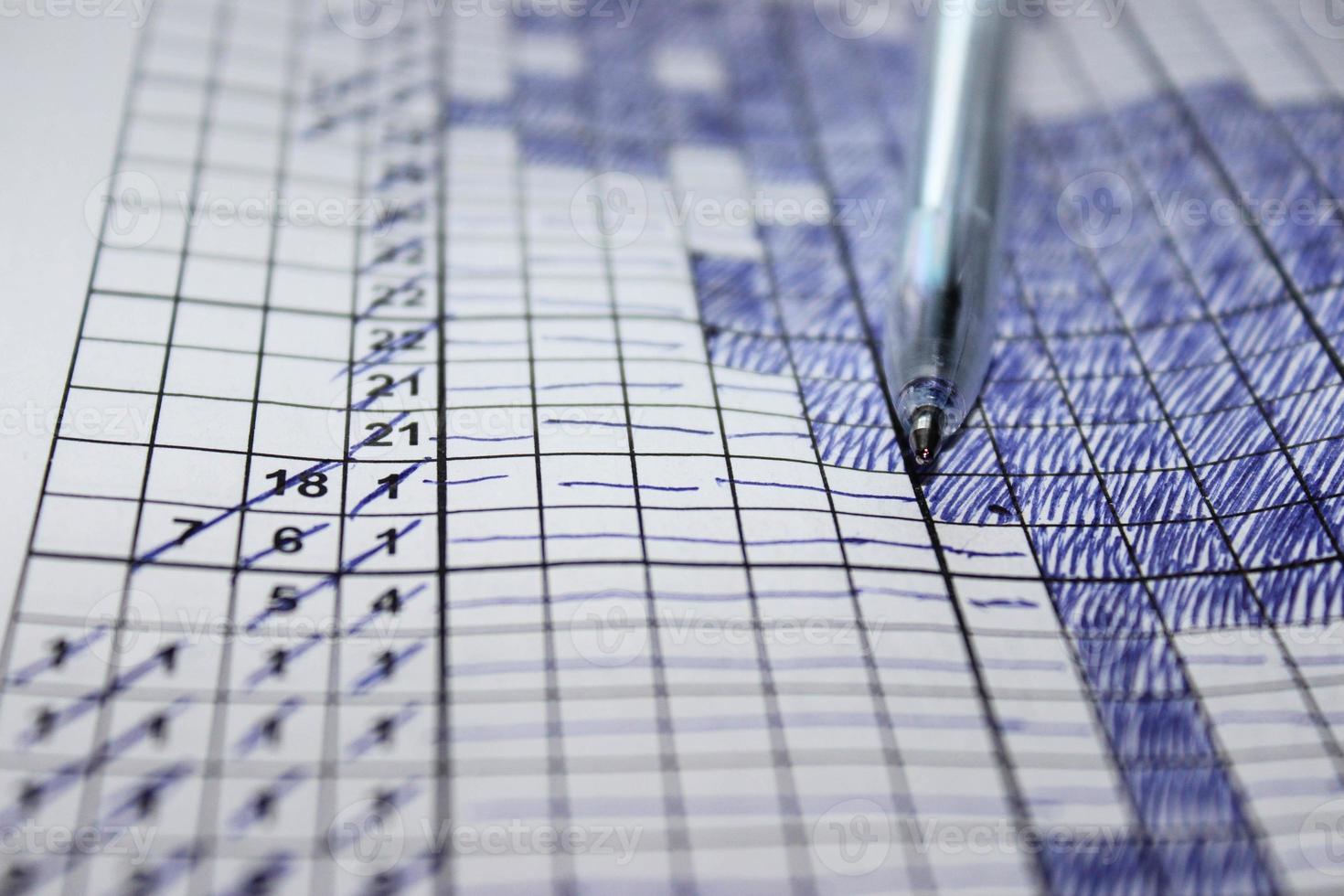 Close up pen on a sheet with a solved Japanese Crossword. Leisure activities photo