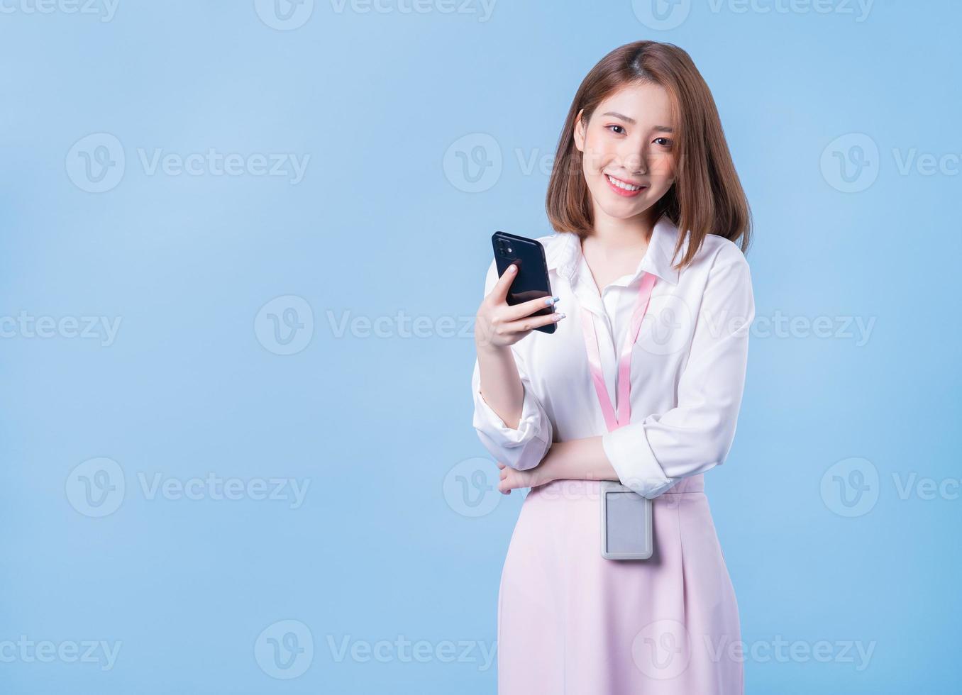 Image of young Asian businesswoman on blue background photo