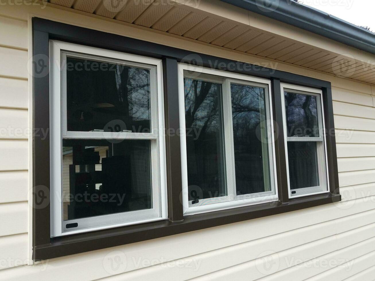 house with new windows installed and dark trim photo