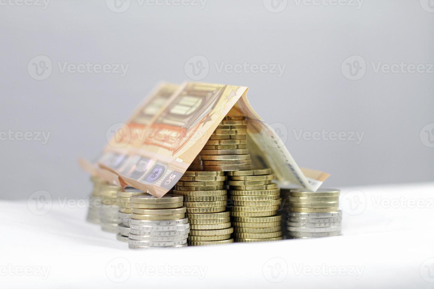 A house made out of Euro coins and bills - Mortgage, rent, investment photo