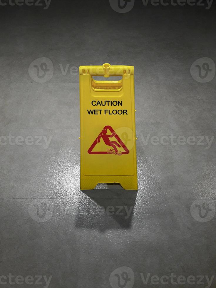 Warning sign is clean yellow On the cement floor photo