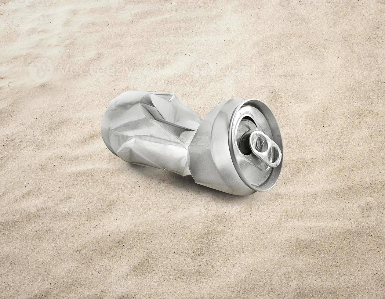 Empty soda or beer cans Crushed waste can be recycled on the sand, beach, sea photo