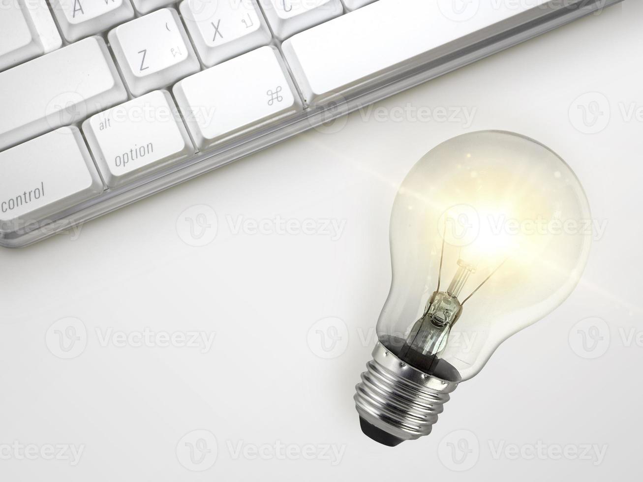 Laptop and glowing light bulb. Self learning or education knowledge and business studying concept. Idea of learning online or e-learning from home photo