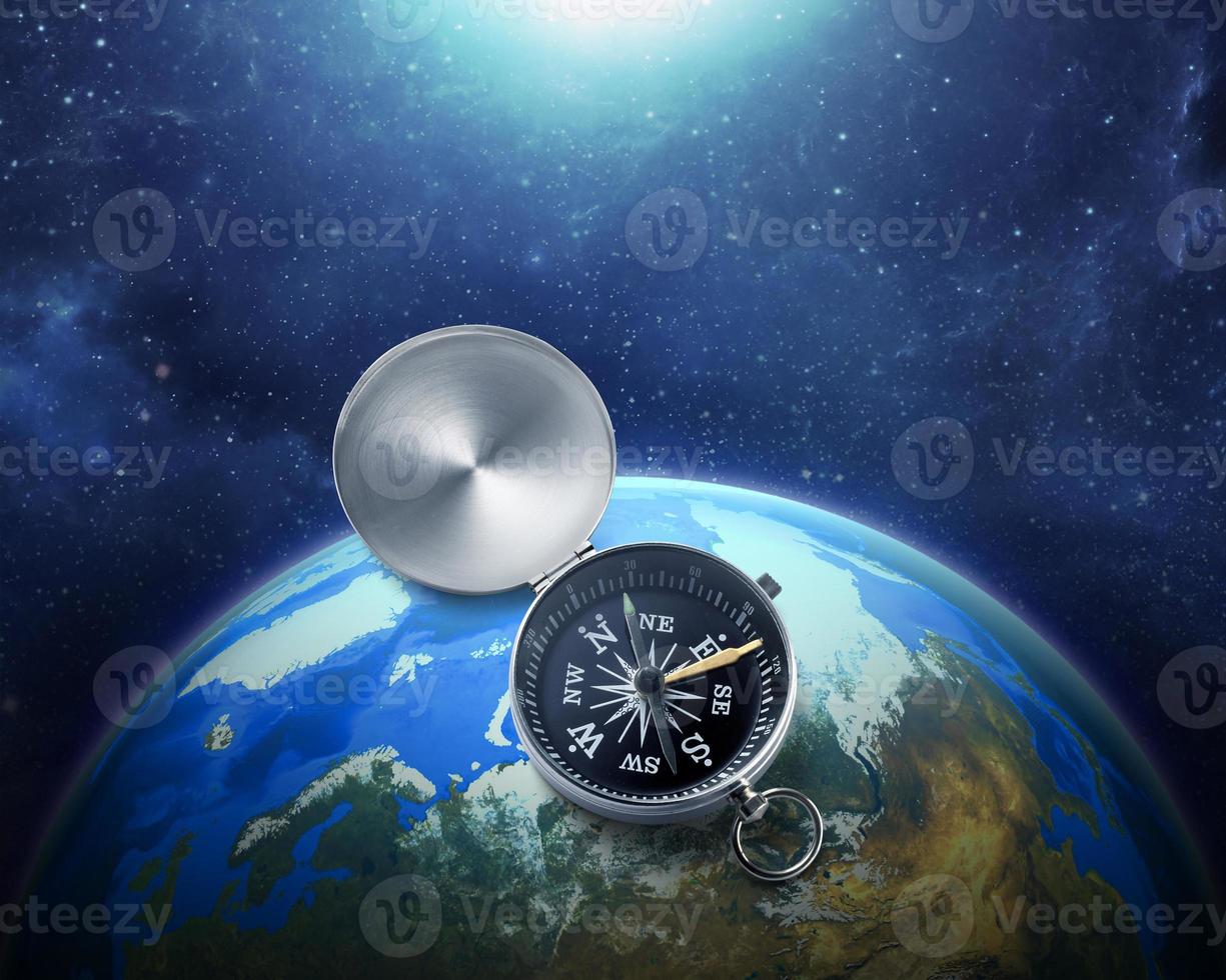 Compass nestled on blue earth in space colorful solar system. . Travel destination and navigation concept around the world photo