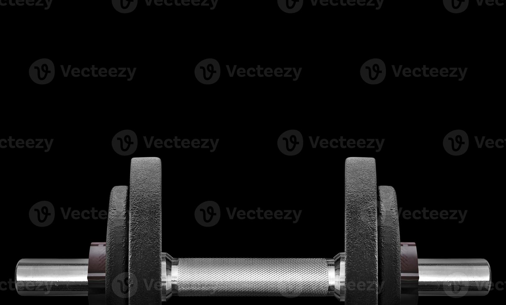 black dumbbell in on a black background and free space for your text photo