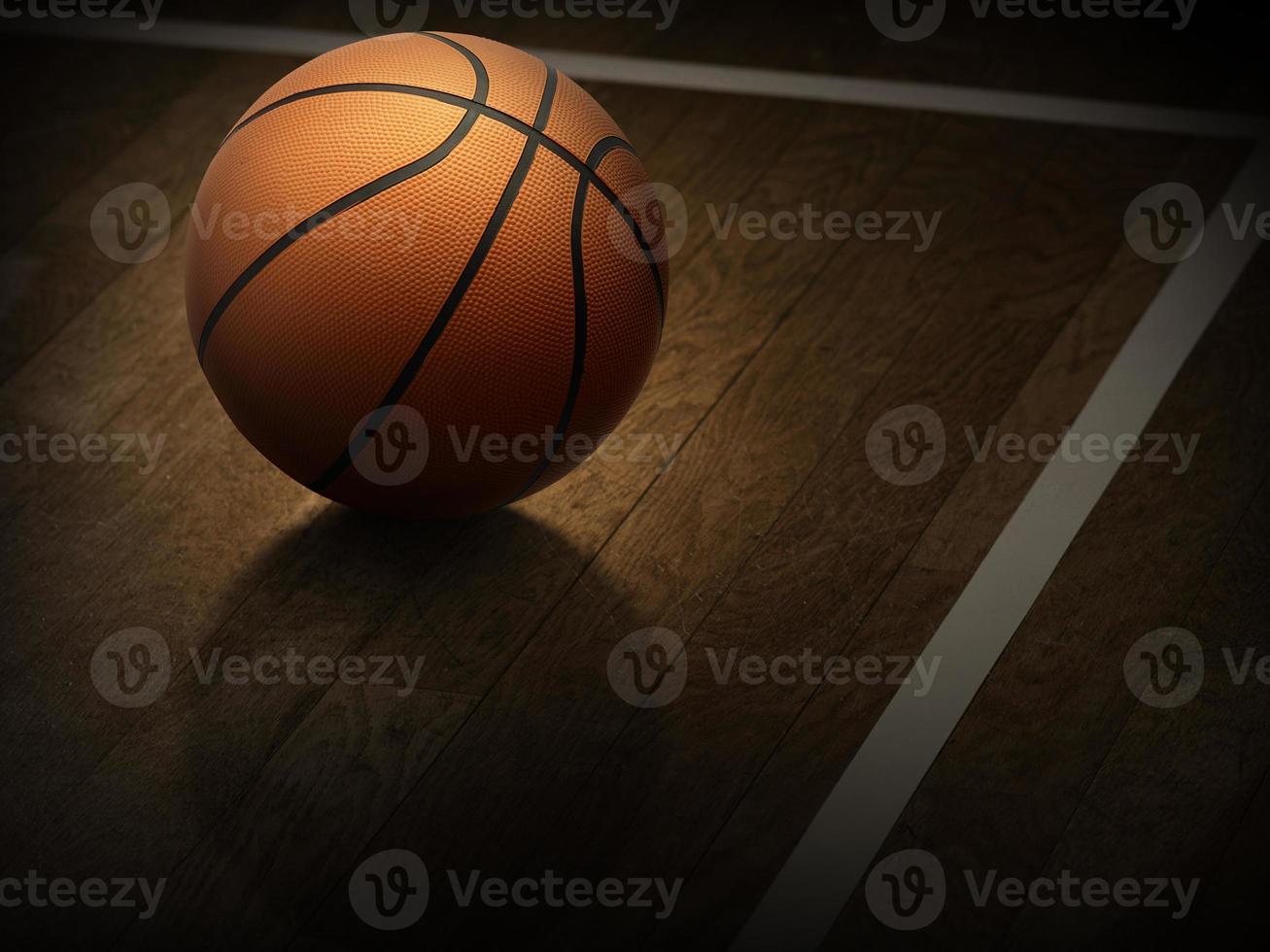 una cancha de baloncesto cubierta con una pelota naranja en un piso de madera foto