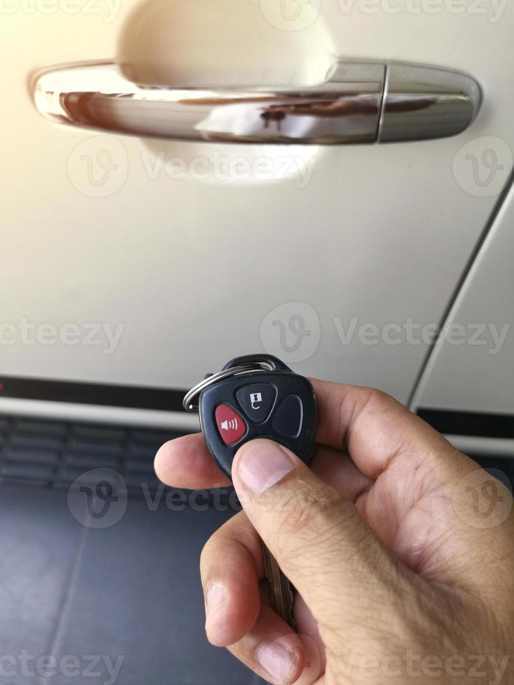 Men's hand presses on the remote control car alarm systems photo