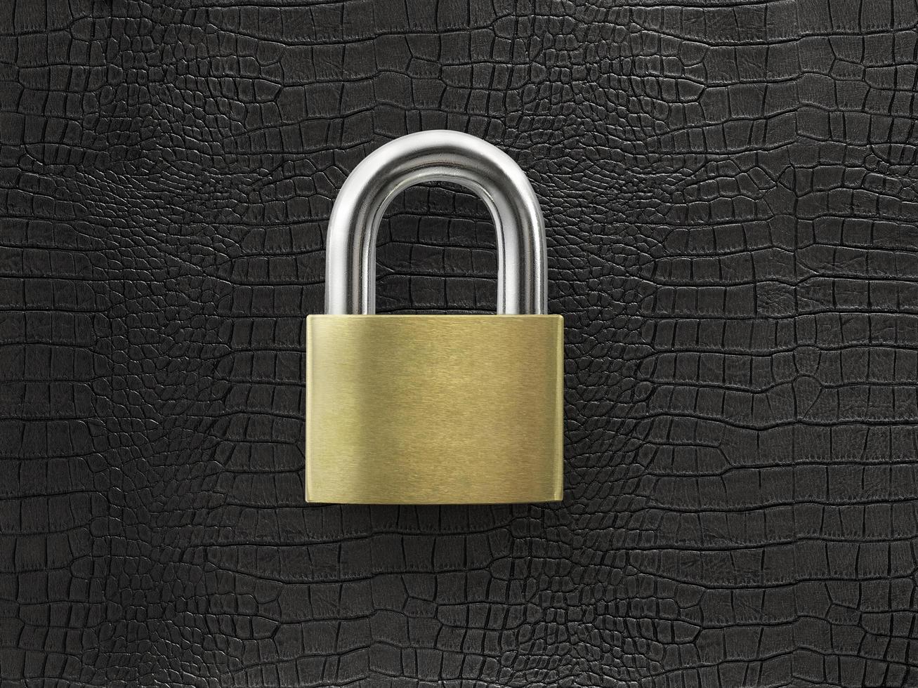 golden closed lock on a black leather background photo
