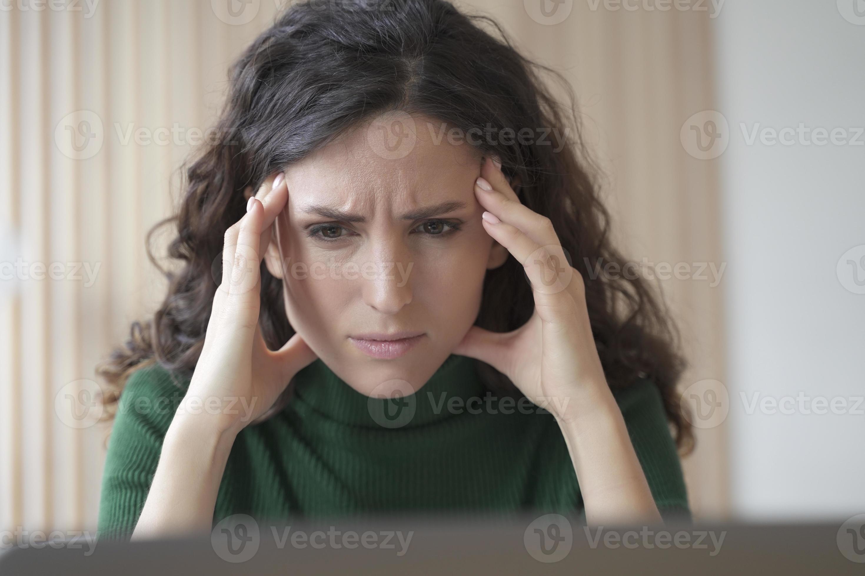Concerned young italian woman employee looking at computer screen with Concerned young italian woman employee looking at computer screen with