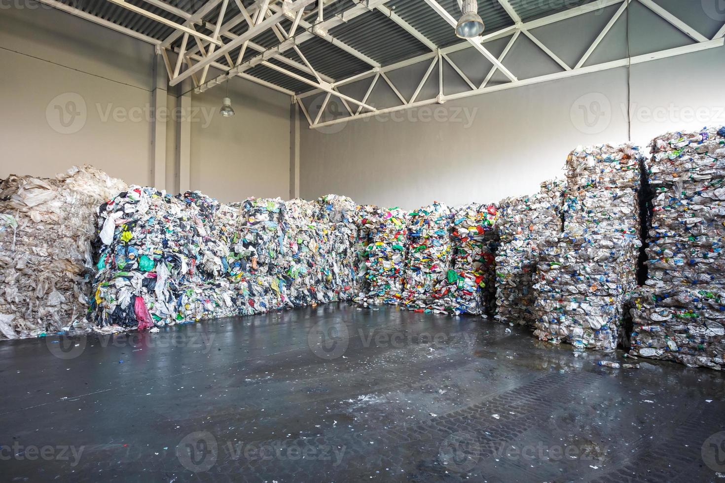 Plastic bales at the waste processing plant. Separate garbage collection. Recycling and storage of waste for further disposal. Business for sorting and processing of waste. photo