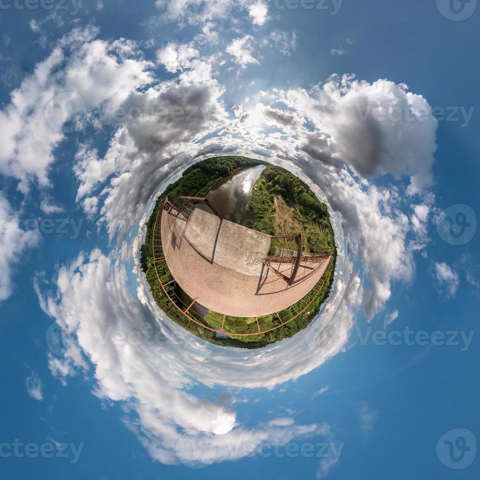 Little planet.  Spherical view  in a field in beautiful day with nice clouds photo