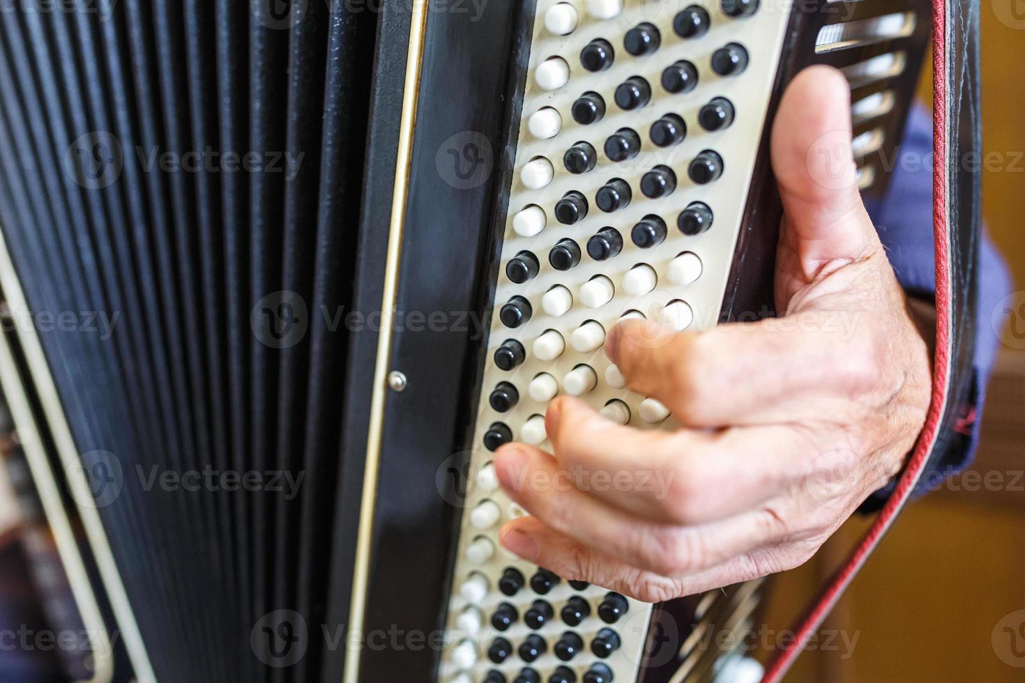 Musician hand playing accordions closeup photo