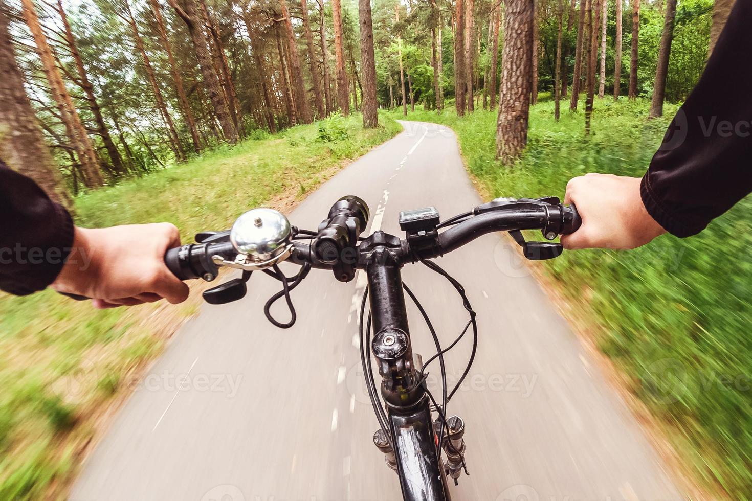 Mountain biking down hill descending fast. View from bikers eyes. Motion blurred photo