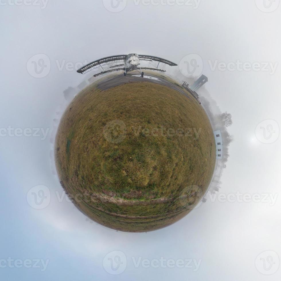 Little planet.  Spherical view of abandoned old plane in the fog photo