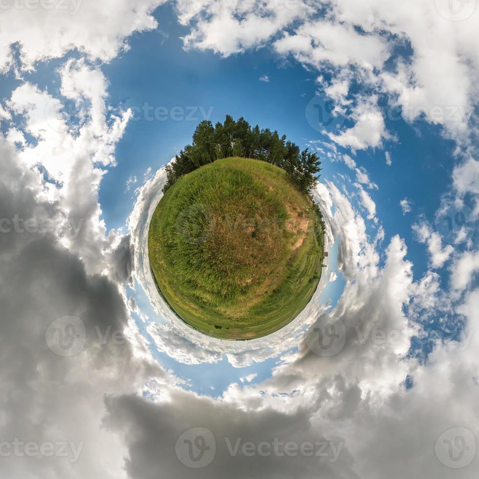 Little planet.  Spherical view  in a field in beautiful day with nice clouds photo