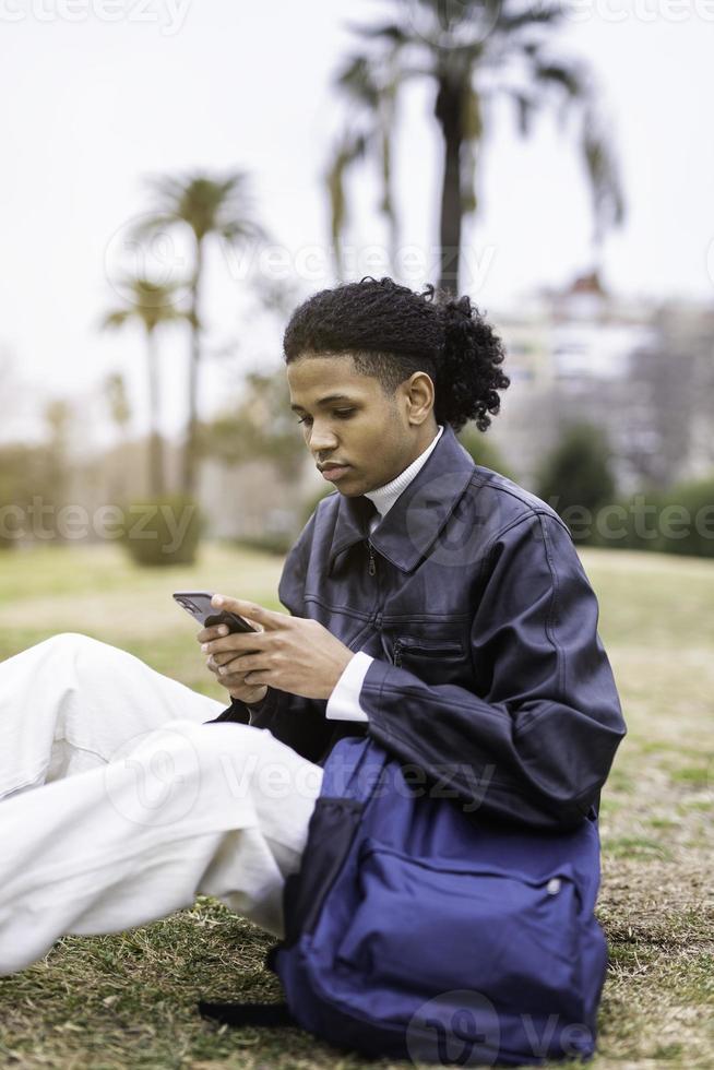 Young african-american man with a mobile phone photo