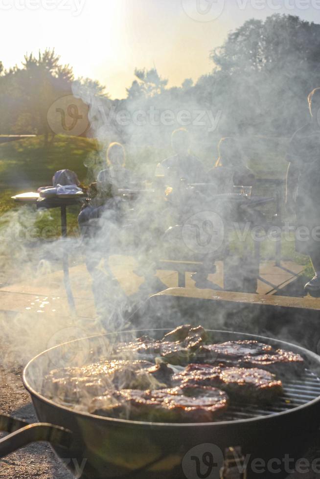 Preparing Barbeque BBQ Campfire and sausages meat steak chicken Germany. photo