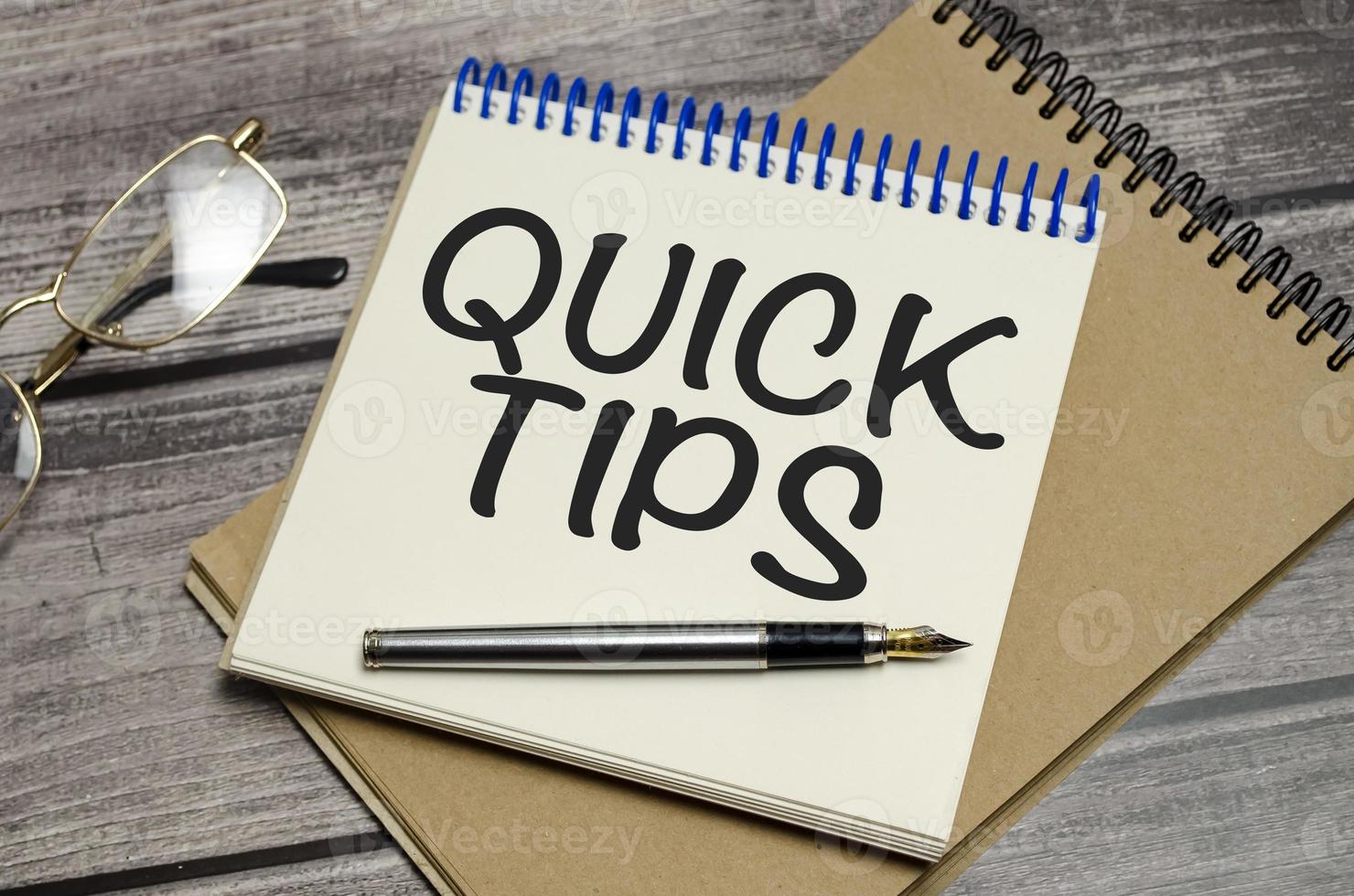 QUICK TIPS words on notebook on wooden background photo