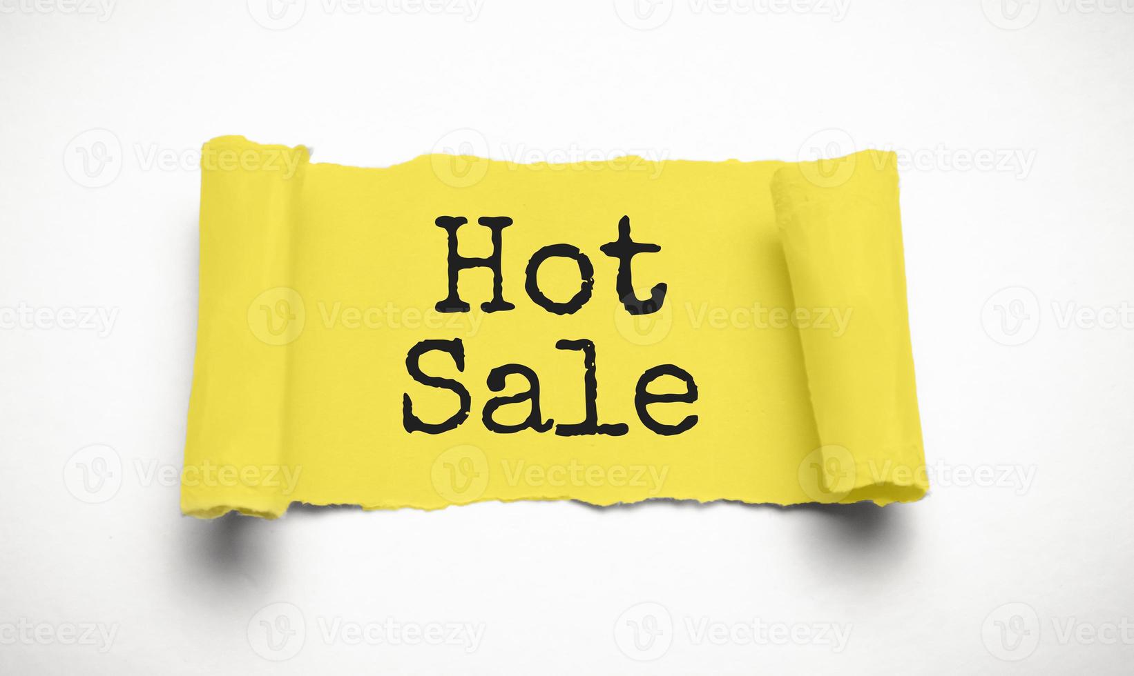 Business and finance. Behind torn white paper on a white background, the text - HOT SALE photo