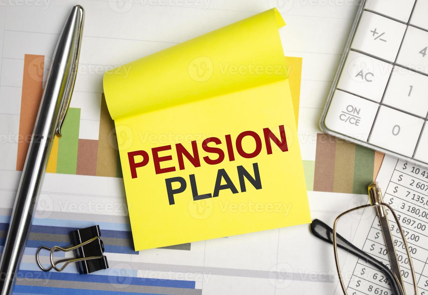 yellow sticker with the text pension plan and charts photo