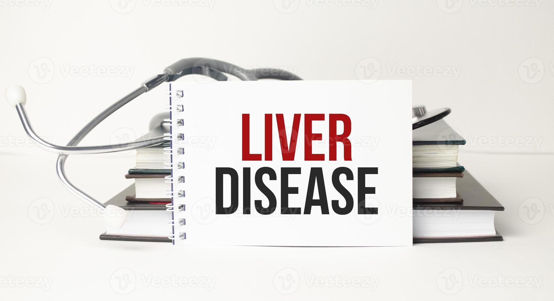 Medicine concept. LIVER DISEASE on notebook with stethoscope photo