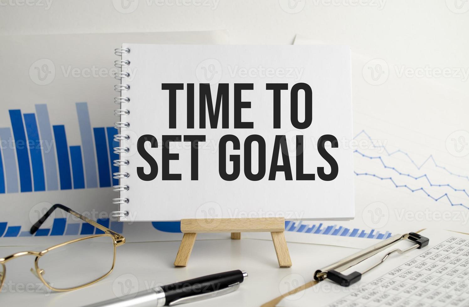 glasses and a notebook with the word TIME TO SET GOALS. Business concept photo