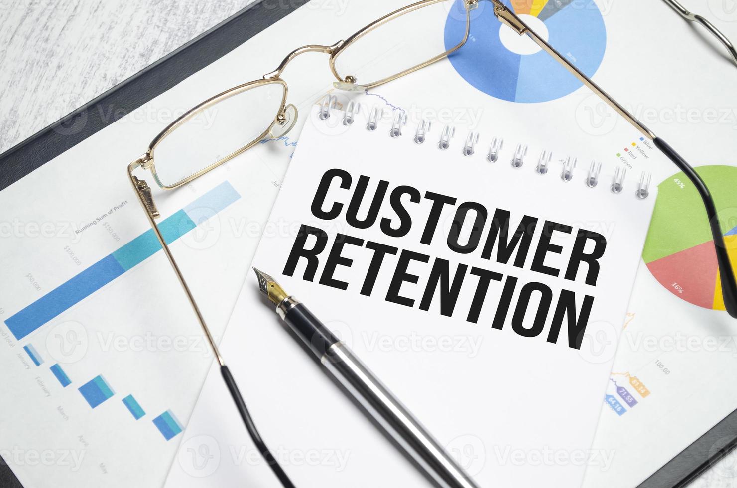 customer retention words on notebook and charts photo