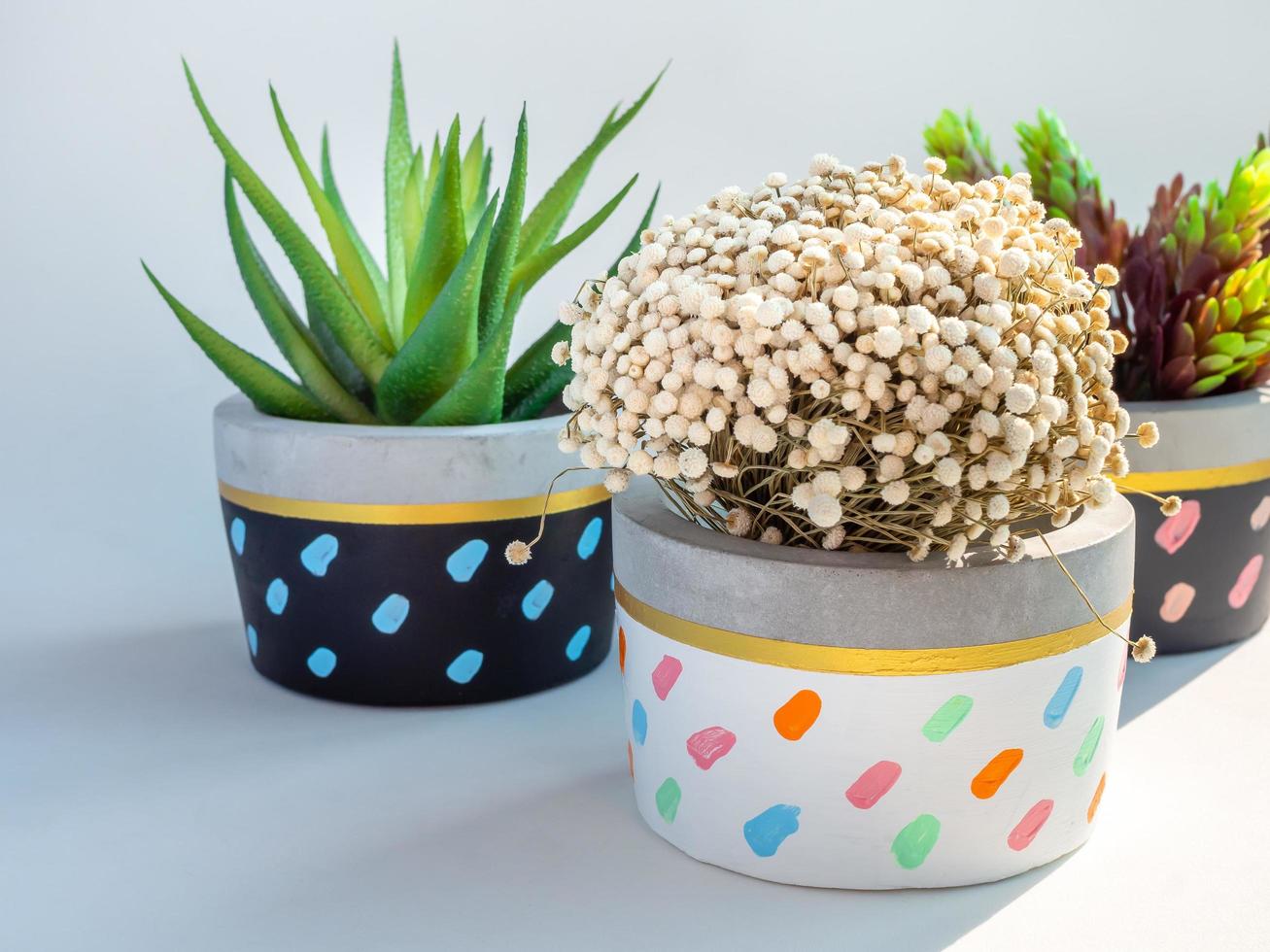 Colorful round geometric planters. Painted concrete pots for home decoration photo