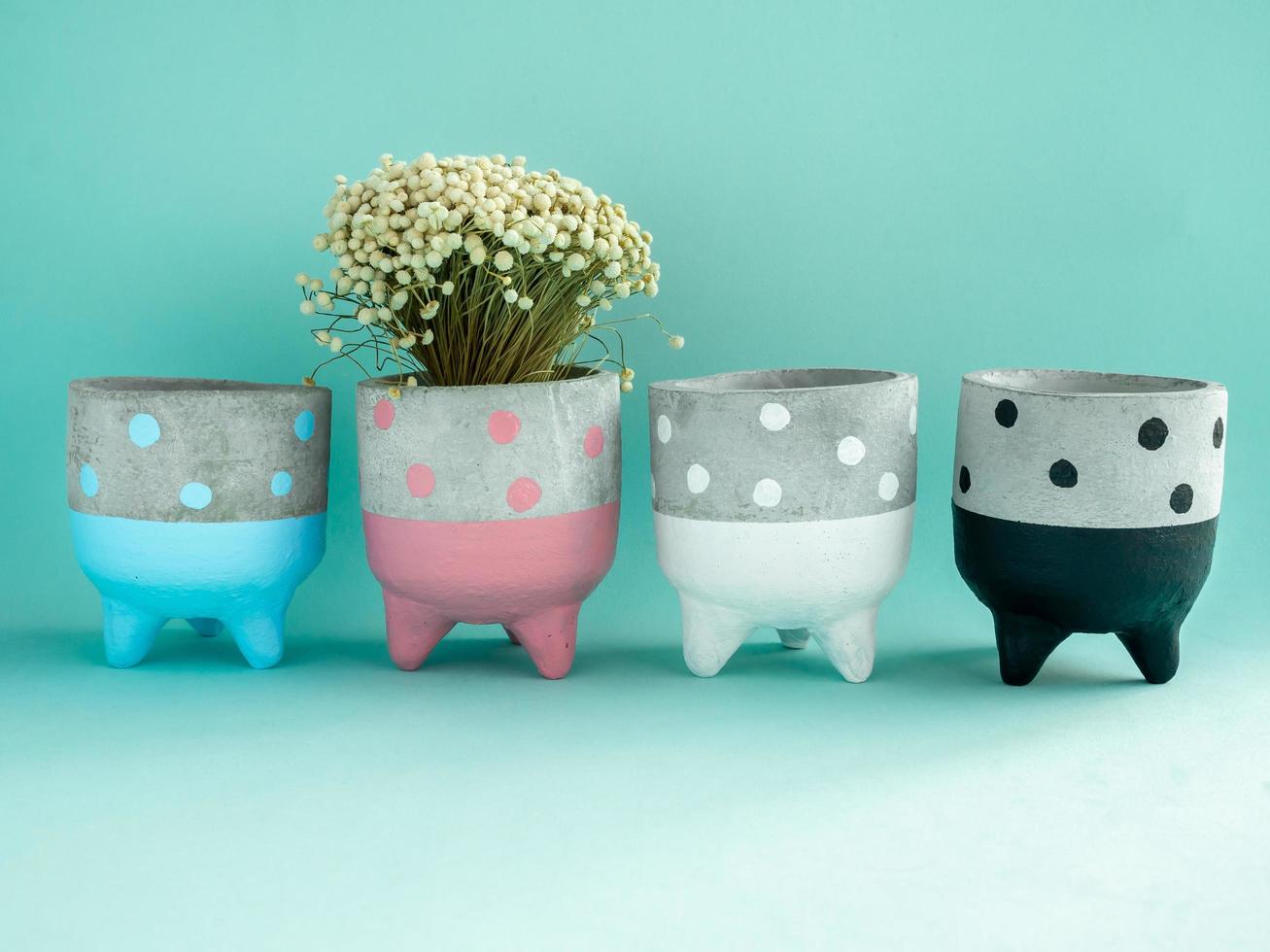 Colorful polka dot concrete planters. Painted concrete planters for home decoration photo