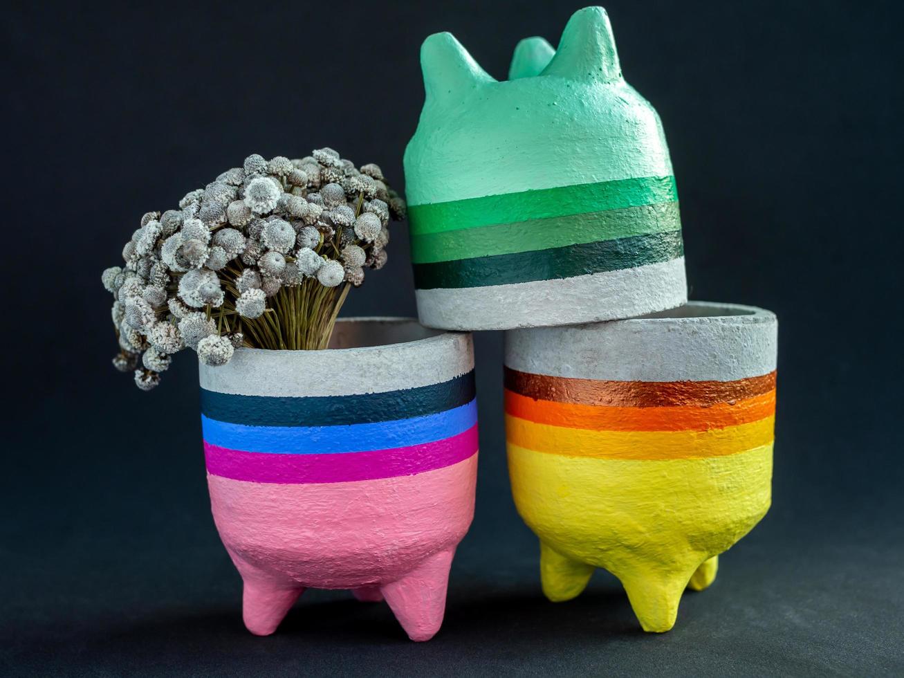 Colorful concrete planters. Painted concrete pots for home decoration photo