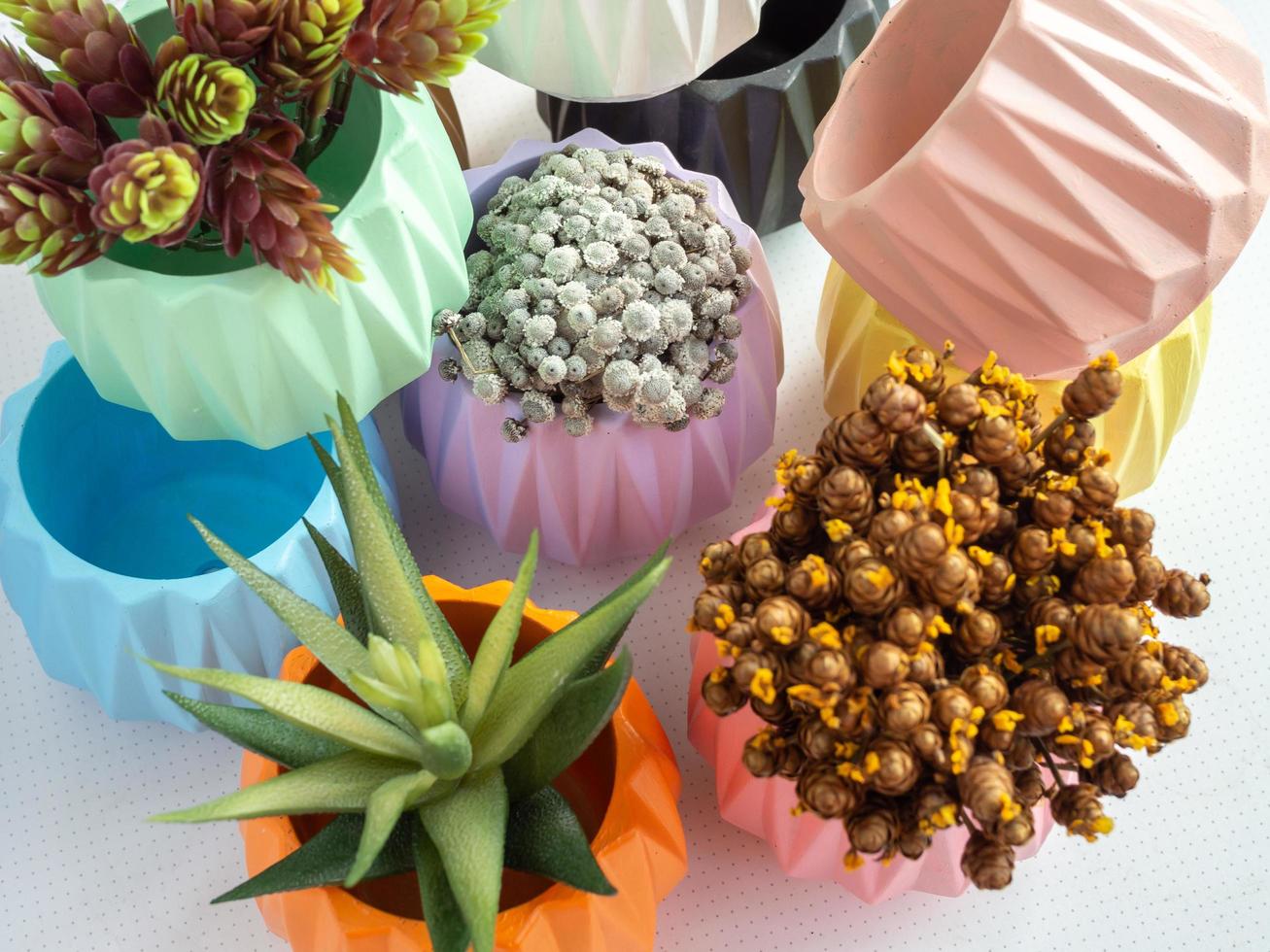 Colorful geometric planters. Painted concrete pots for home decoration photo