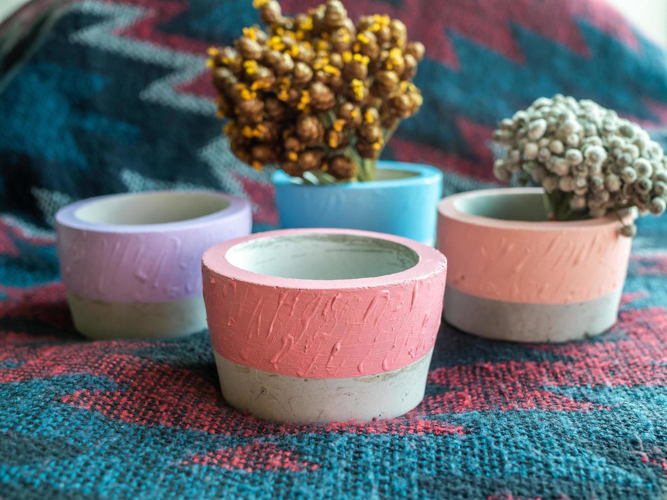 Colorful round geometric planters. Painted concrete pots for home decoration photo