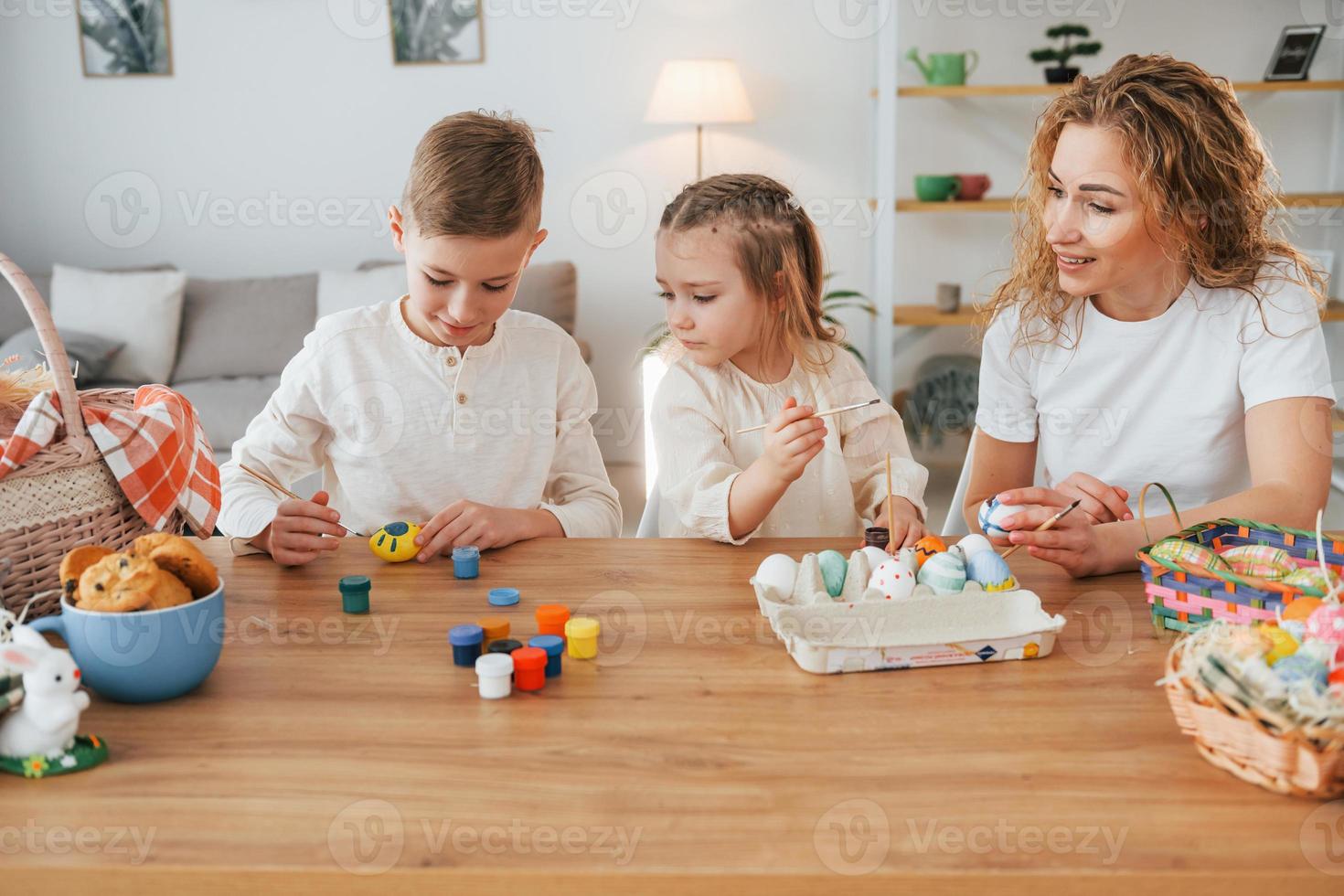 Mother with her son and daughter. Happy family celebrating Easter holidays together photo