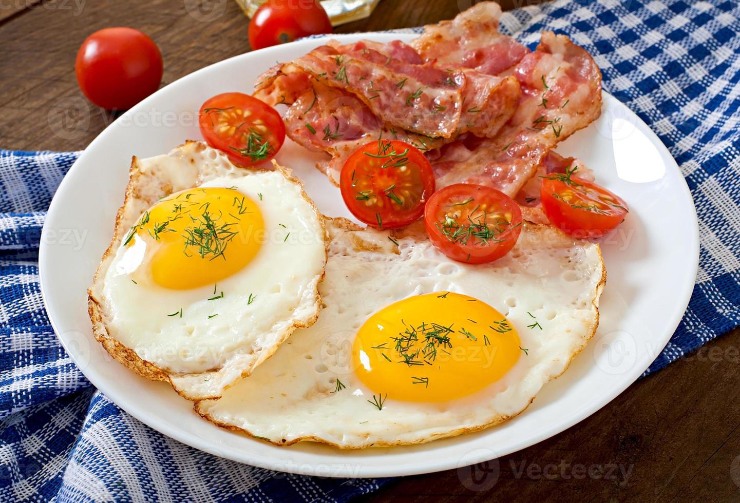 English breakfast - toast, egg, bacon and vegetables in a rustic style on wooden background photo