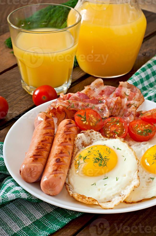 English breakfast - toast, egg, bacon and vegetables in a rustic style on wooden background photo