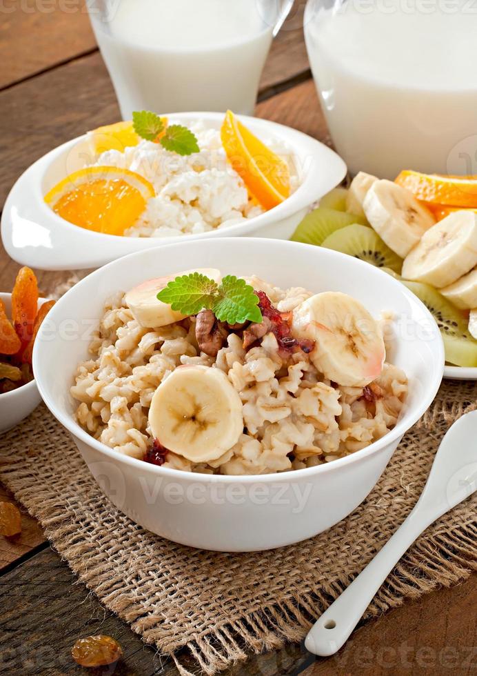 Healthy breakfast - oatmeal, cottage cheese, milk and fruit photo