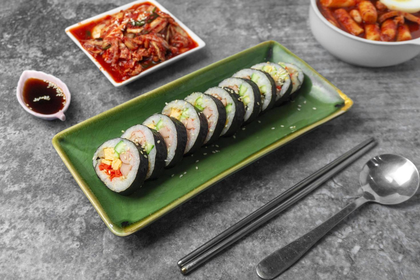 Korean food, Gimbap or Kimbap is seaweed rice roll and kimchi side dish. photo