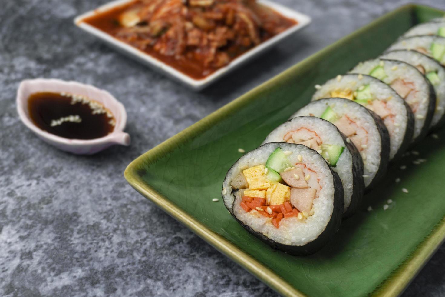 Korean food, Gimbap or Kimbap is seaweed rice roll and kimchi side dish. photo