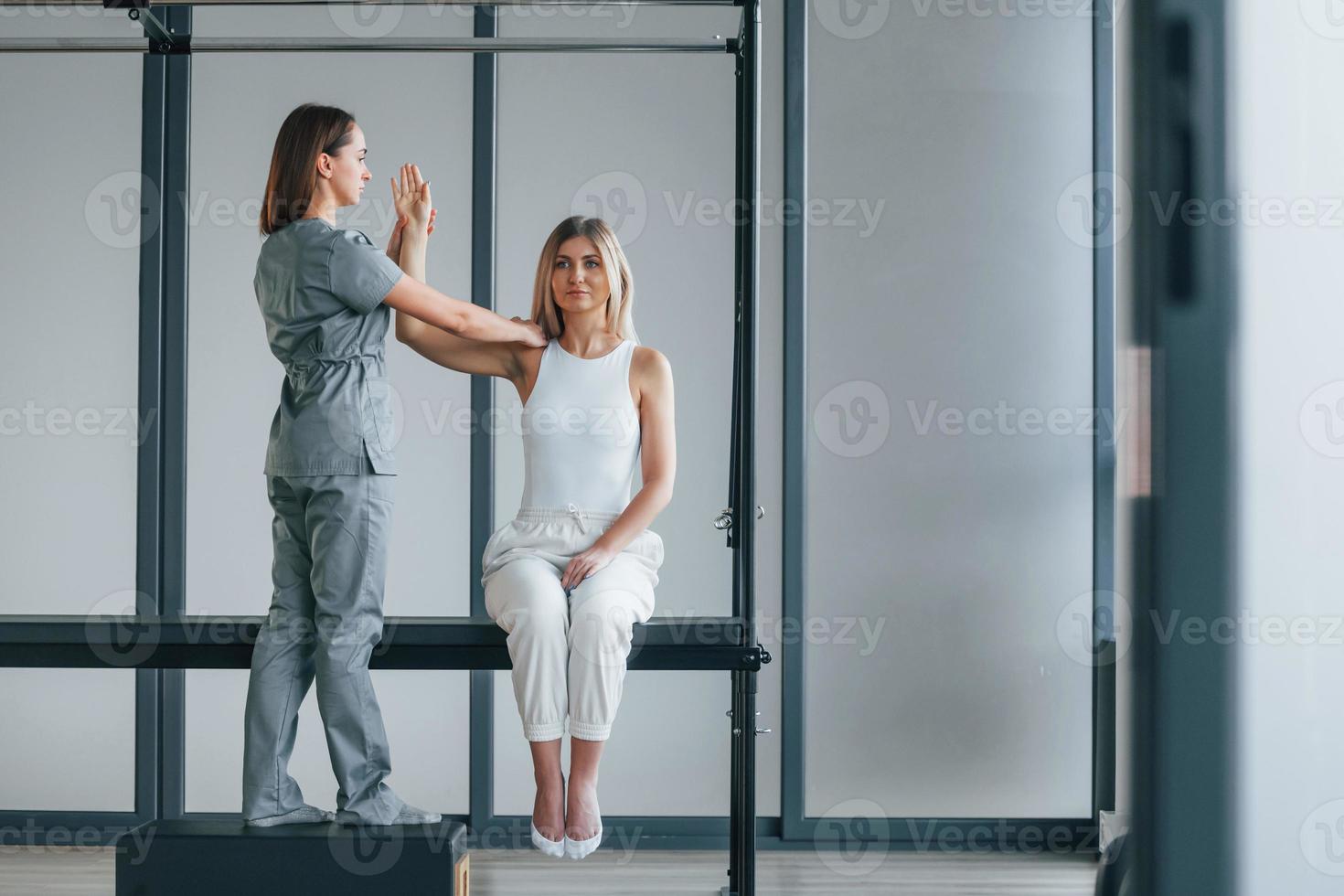 Moving the hand. Woman is in health center getting help by doctor photo