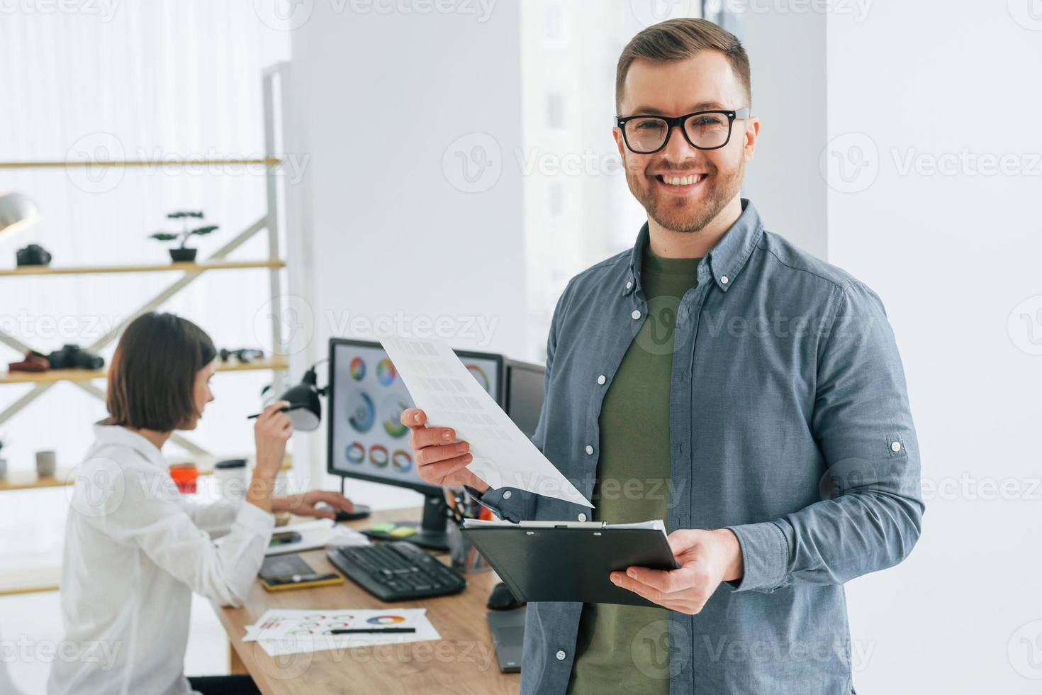 Looking at the camera. Two designers working together in the office photo