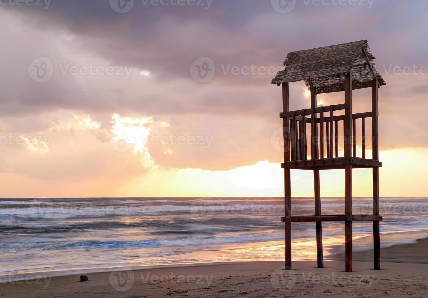 Landscape of beach with the wooden lookout tower photo