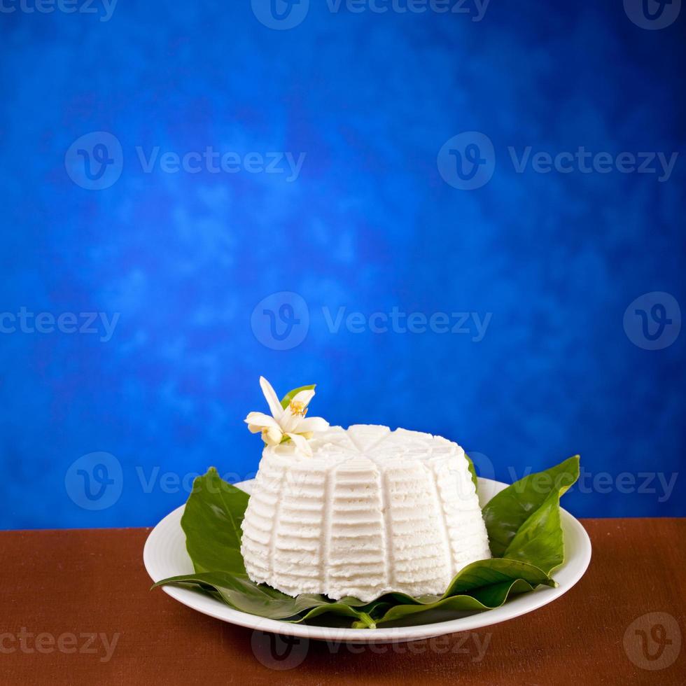 Ricotta on wooden table and blue background photo