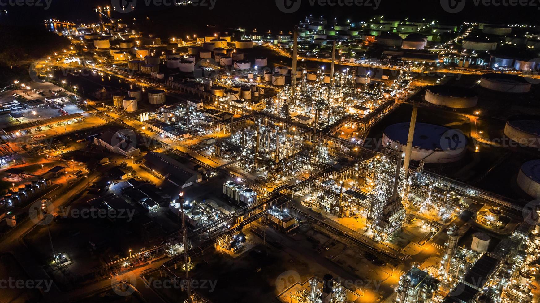 Oil refinery industry at night photo