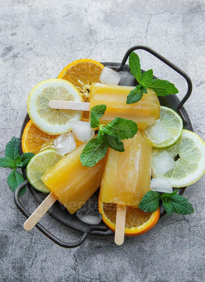 Natural juicy orange popsicles. photo