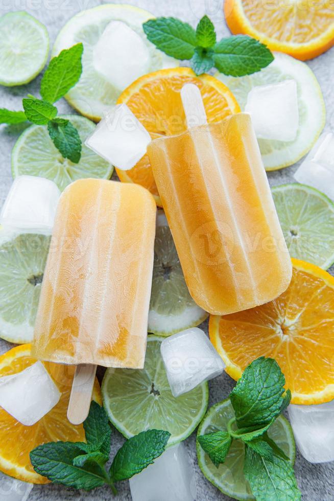 Natural juicy orange popsicles. photo